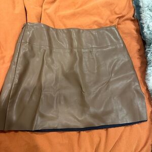 Cute faux brown leather mini skirt. Never worn with a cute side slit
